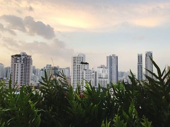 Buildings in city against sky during sunset