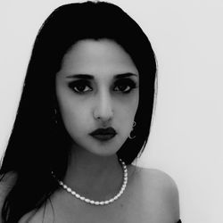 Close-up portrait of a beautiful young woman over white background