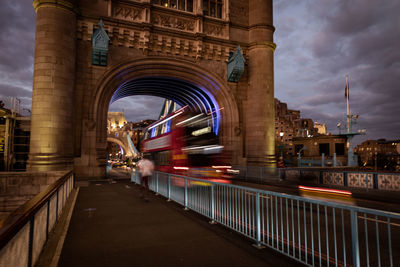Blurred motion of illuminated bridge at night