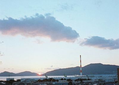 Scenic view of river and mountains against sky