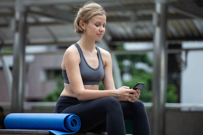 Full length of woman using mobile phone