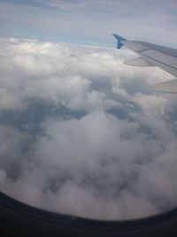 Cropped image of airplane wing over landscape