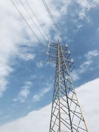 Low angle view of electricity pylon against sky