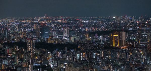 High angle view of illuminated city buildings at night