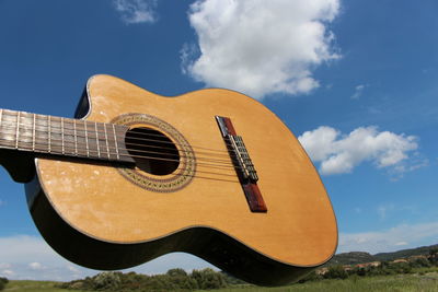 Low angle view of guitar against sky