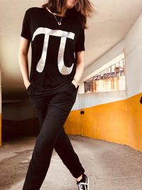 Low section of woman walking against wall