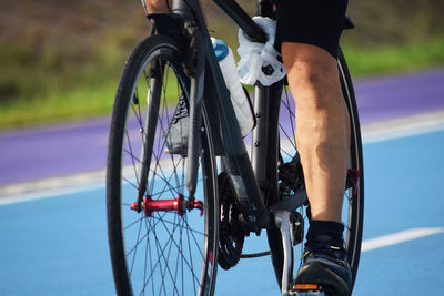 Low section of man riding bicycle