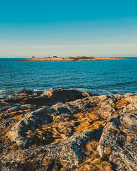 Scenic view of sea against blue sky