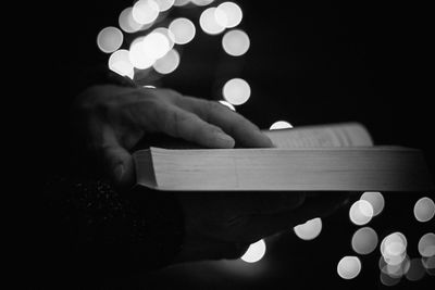 Close-up of hand holding illuminated lighting equipment