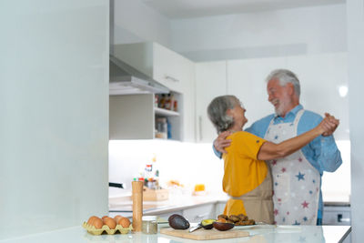 Portrait of senior female friends standing at home