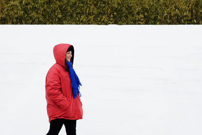 Woman standing on field during winter