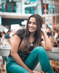 Portrait of smiling woman sitting outdoors