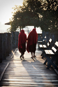 Rear view of men walking on cross