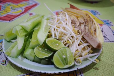 High angle view of chopped vegetables in plate on table