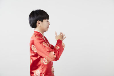 Side view of a boy against white background