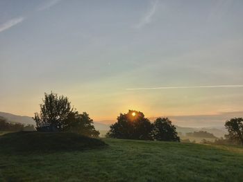 Scenic view of field against sky during sunset