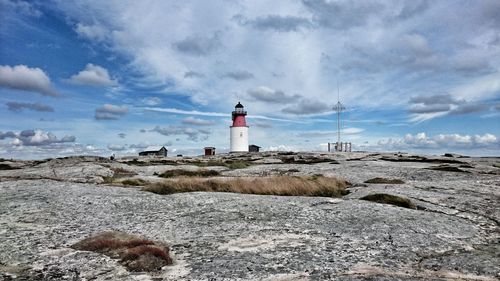 Lighthouse against cloudy sky