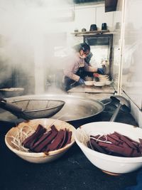 Close-up of man preparing food in basket