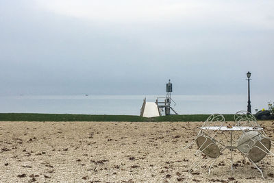 Lifeguard hut on beach against sky