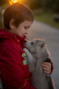 Close-up of boy with dog