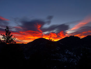 Scenic view of silhouette mountains against sky during sunset