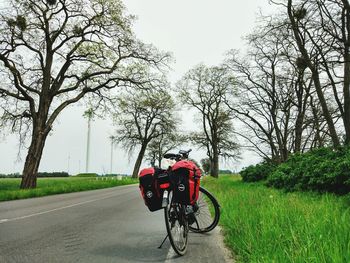 Man riding bicycle on road against clear sky