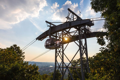 Low angle view of crane against sky