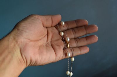 Close-up of hand holding jewelry