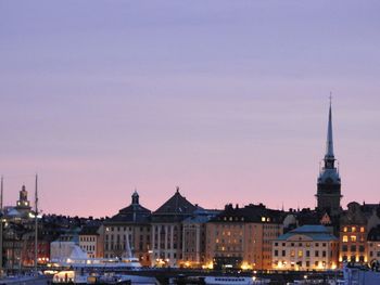 Buildings in city at sunset