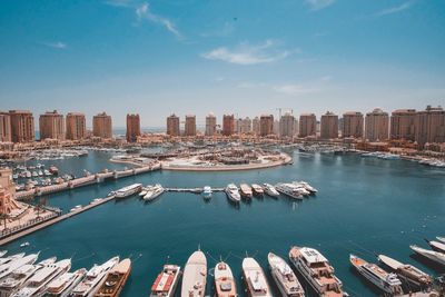 High angle view of buildings by sea against sky