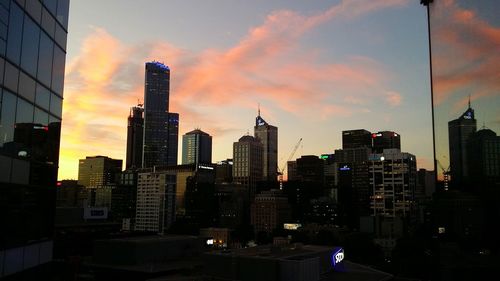 Skyscrapers in city at dusk