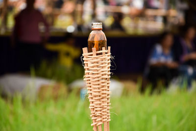 Close-up of bottle on plant on field