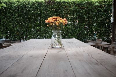 Flowers in jar on table at cafe