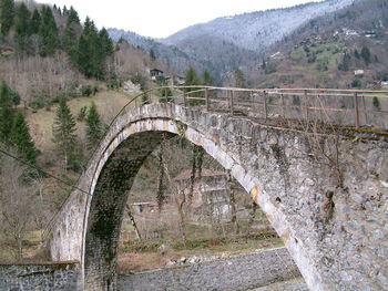 Arch bridge against mountains