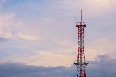 Low angle view of communications tower against sky during sunset