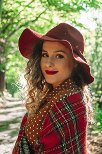 Portrait of beautiful woman standing at forest