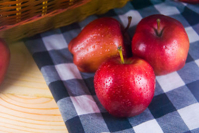 High angle view of strawberries in basket on table