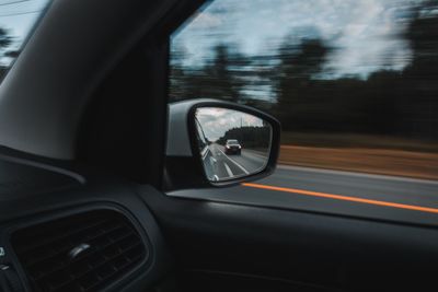 Reflection of car on side-view mirror