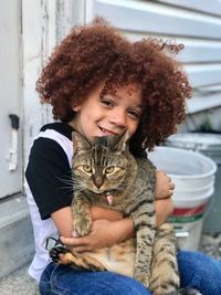 Portrait of young woman with cat