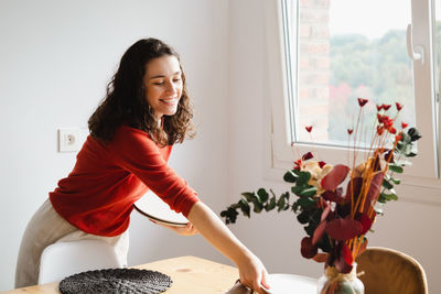 Portrait of young woman sitting at home