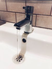 Close-up of faucet in bathroom