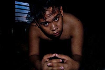 Portrait of teenage girl sitting at home