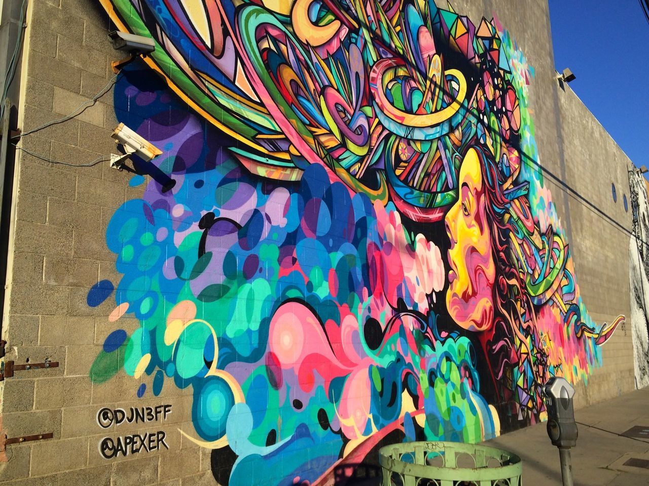 art, art and craft, creativity, multi colored, graffiti, text, human representation, wall - building feature, built structure, communication, western script, architecture, low angle view, street art, building exterior, colorful, mural, craft, blue