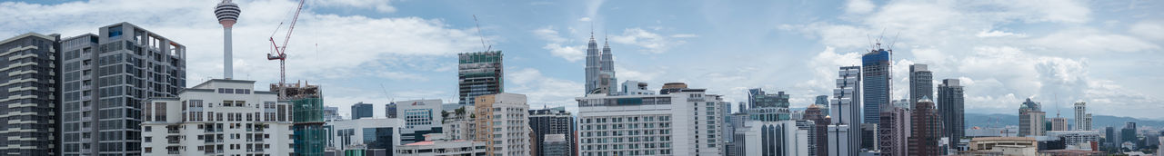 Panoramic view of urban skyline against sky