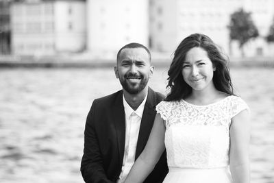 Portrait of smiling young couple standing outdoors