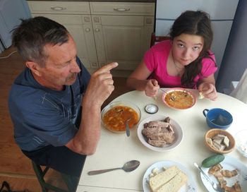 High angle view of man eating food at home