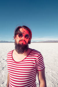 Mid adult man at beach against sky