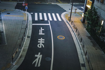 High angle view of road sign on street in city