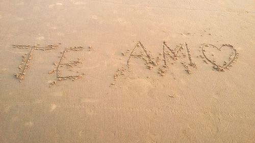 High angle view of text on sand at beach