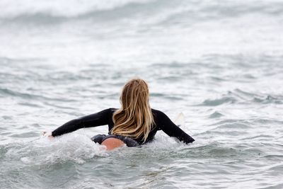 Rear view of woman in sea